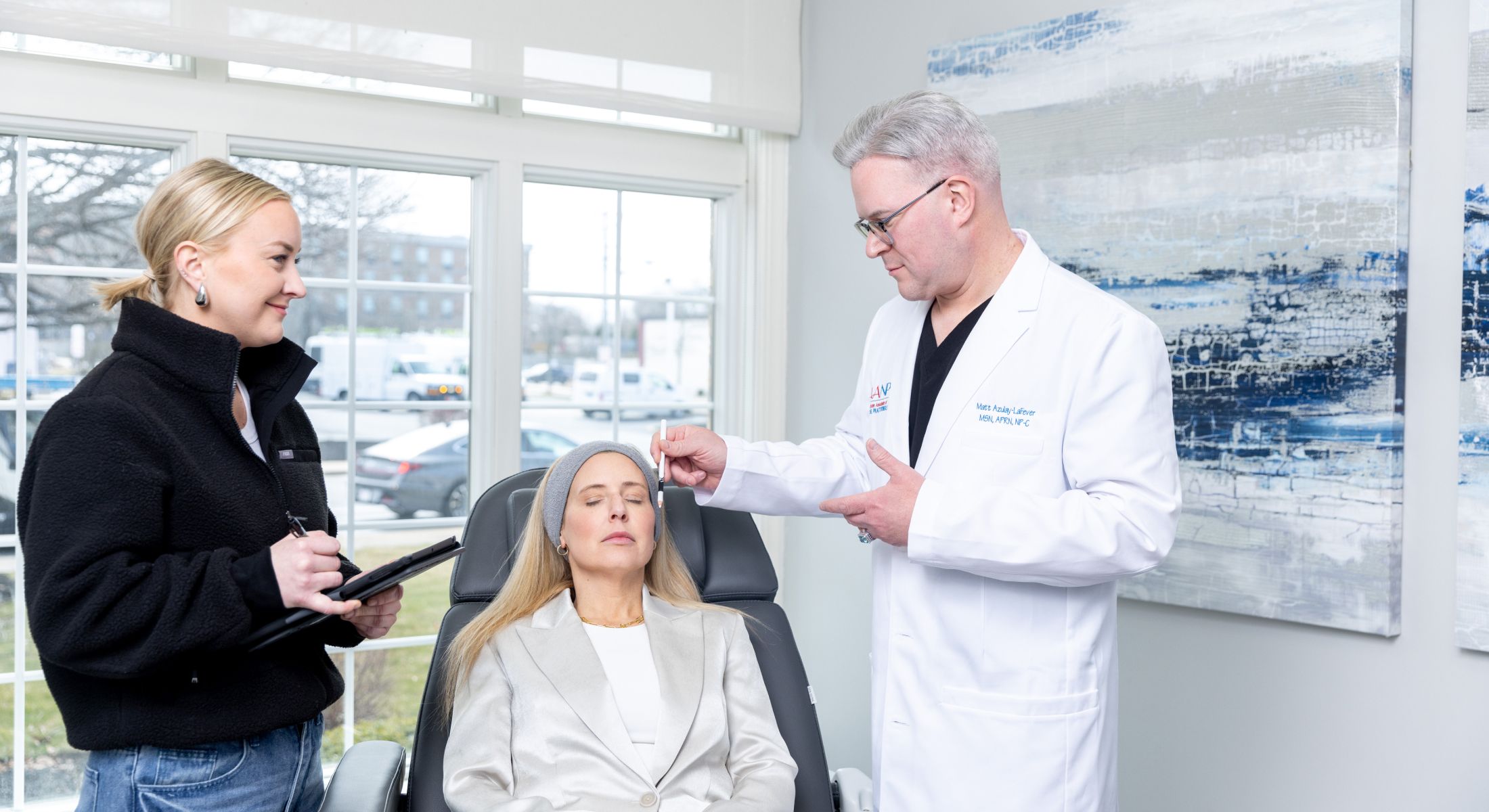 Matt Azulay-LaFever and a student with a patient model sitting in a chair